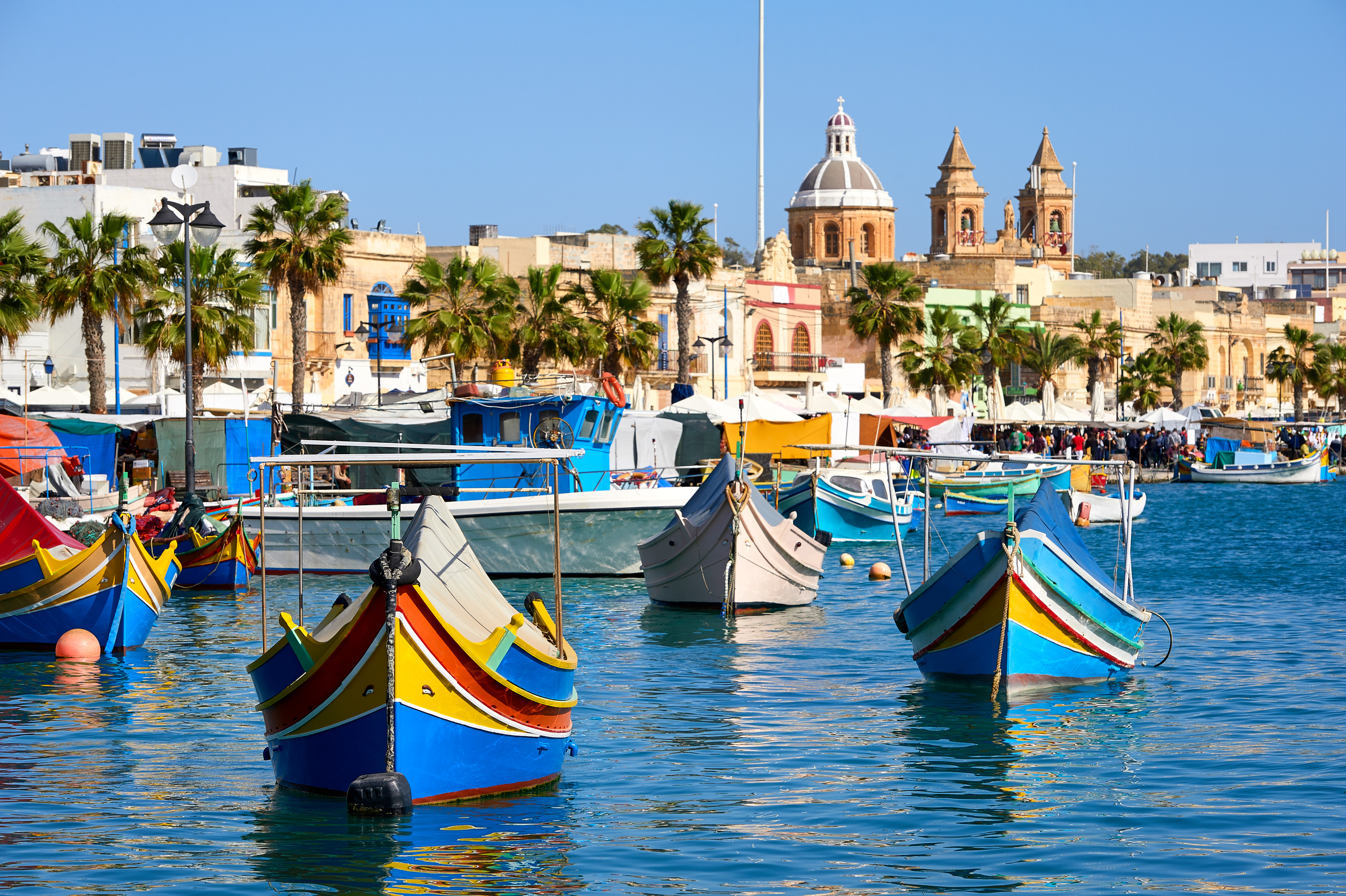 Marxaslokk harbor with traditional maltese eyed boats - luzzu on the bright sunny day.